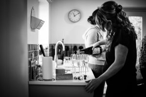 Bridesmaids pouring drinks
